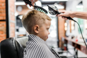 Barber,Trimming,A,Child,In,A,Barbershop,Side,View